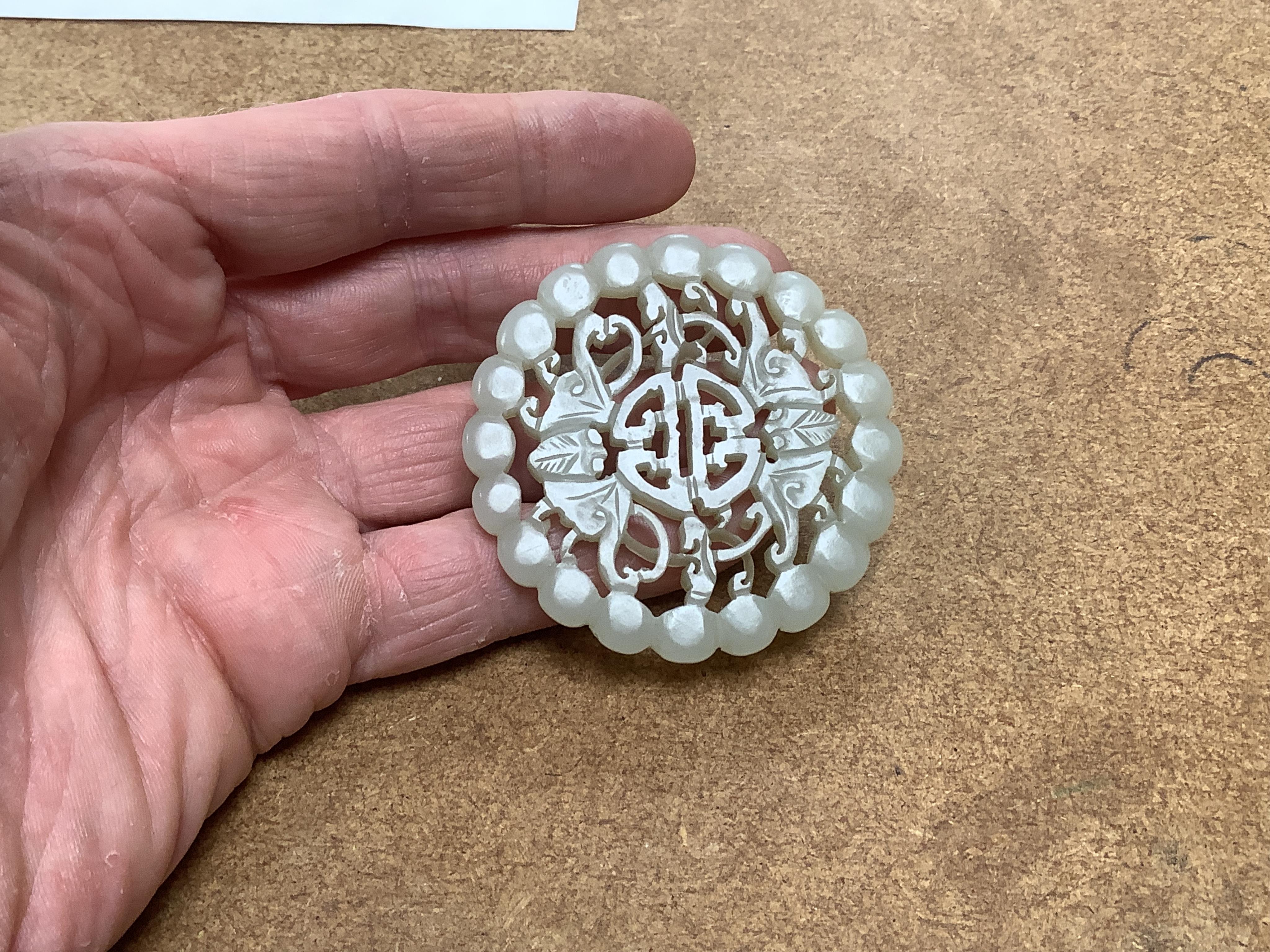 Two Chinese celadon jade circular plaques, 19th century, 5.5cm diameter